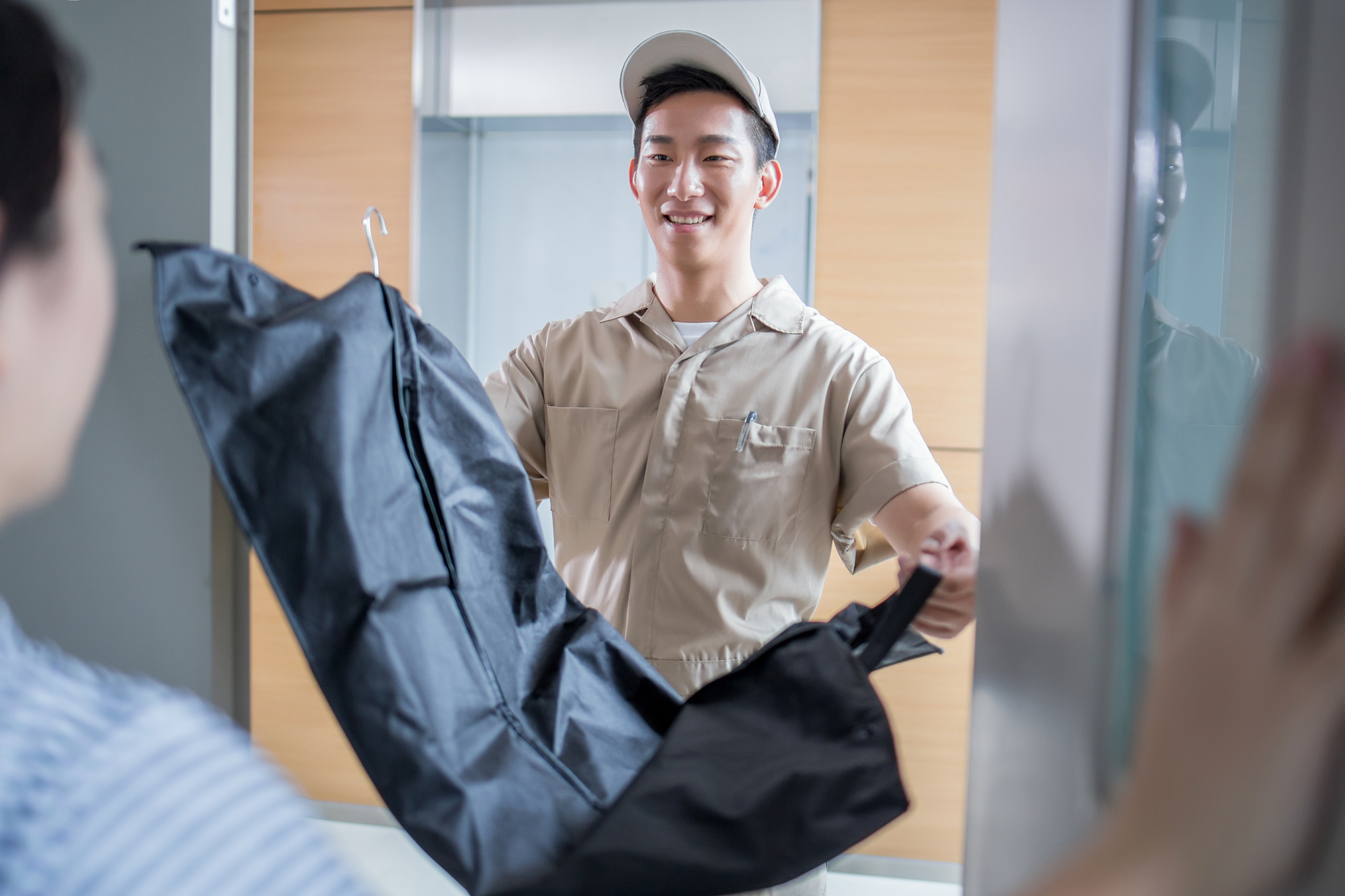 Delivery Man Delivering Clothes To Homeowner