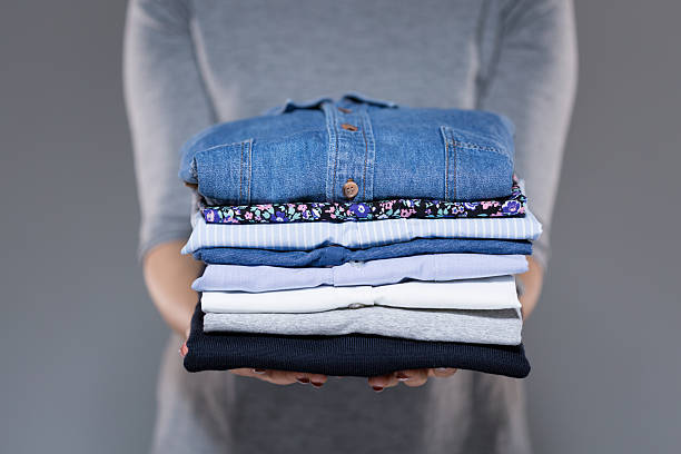 Woman Holding Pile Of Clothes